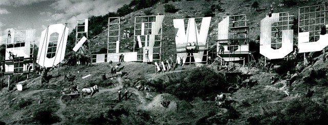 Black and white image of the famous Hollywood sign, with huge letters spelling out the name across a mountain landscape