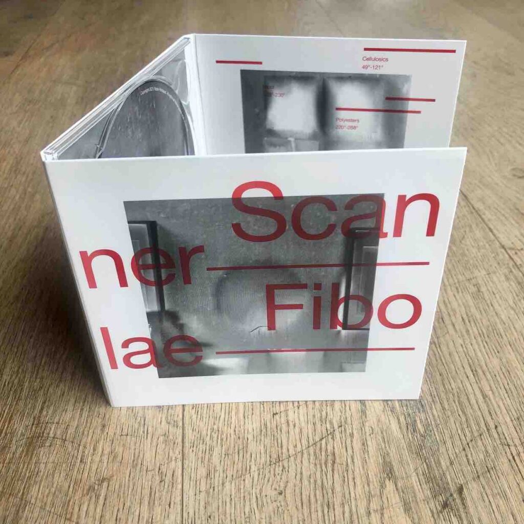CD on a wooden floor, opened up. Black and white abstract images on the cover with a large text in red Scanner Fibolae on the front