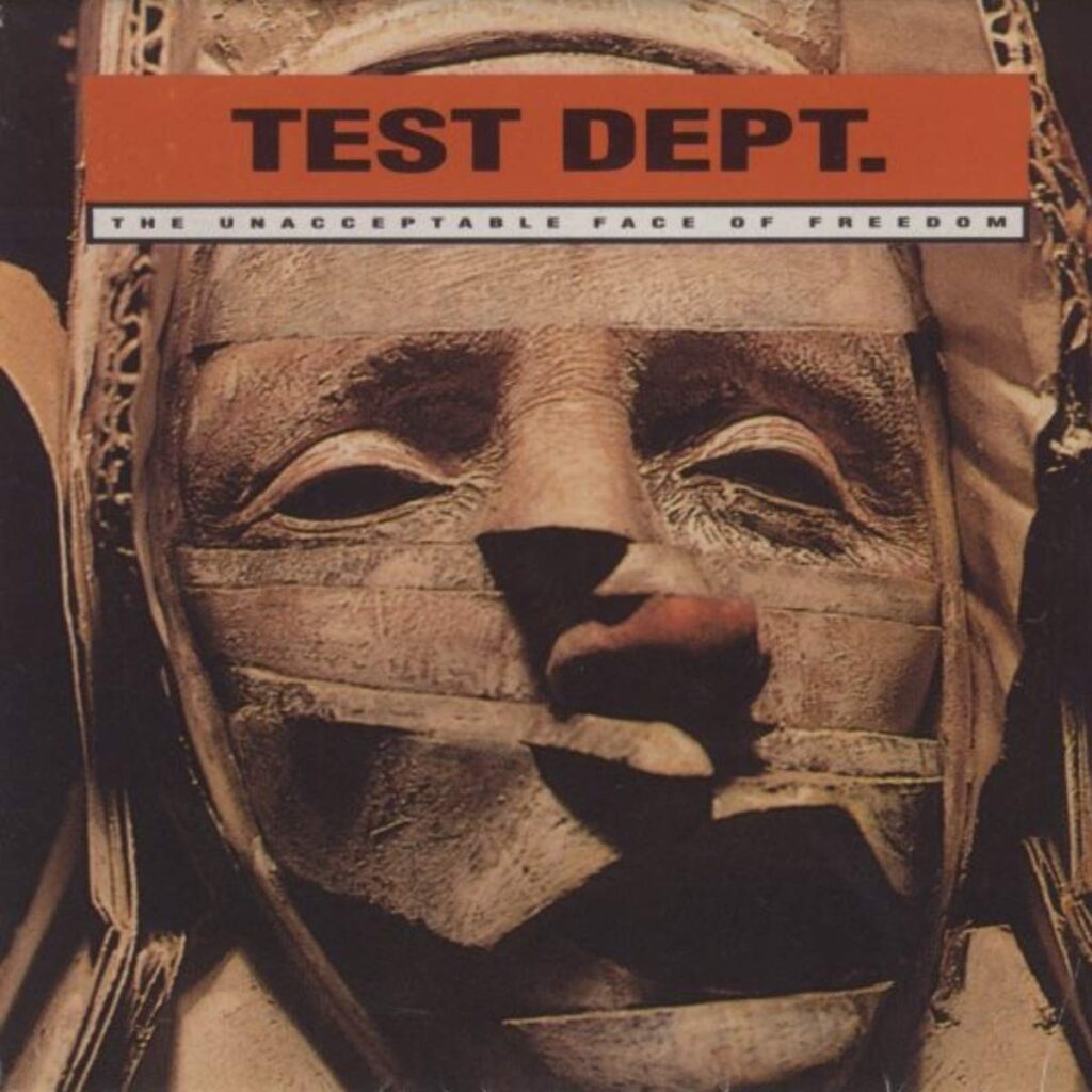 An LP over with a distorted face made out of stone, an artful sculpture. Text above this reads Test Dept - The unacceptable face of freedom