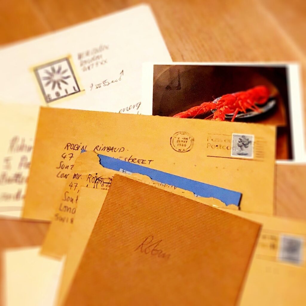A collection of letters and cards all addressed to Robin Rimbaud, from the band Coil, with a photo of a Dali artwork featuring a lobster