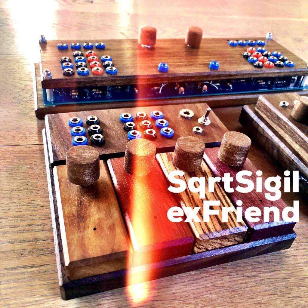 A very colourful image of three unusual looking wooden devices sit on the floor. A streak of light can be seen across the middle of the photo. The wooden devices each have wooden knobs on their surface and switches and buttons. Across the bottom of the image a text reads SqrtSigil exFriend