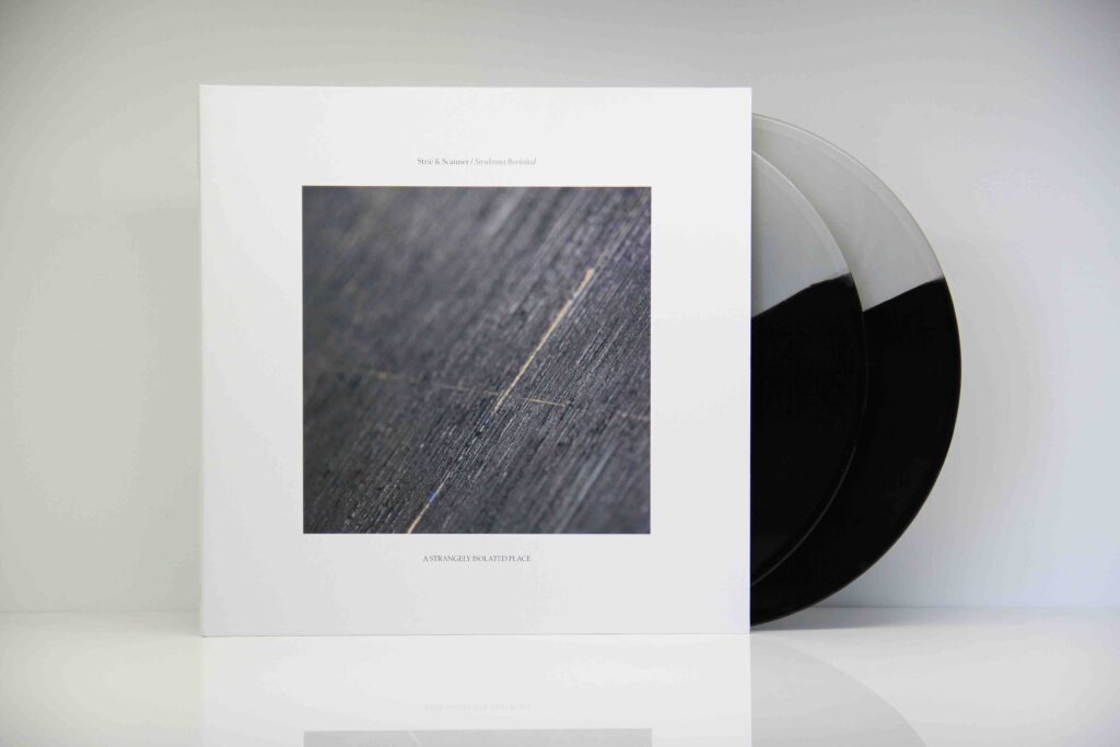 Album sleeve on a white background, with two vinyl records peeking out of the sleeve, with half black/half white colour on it