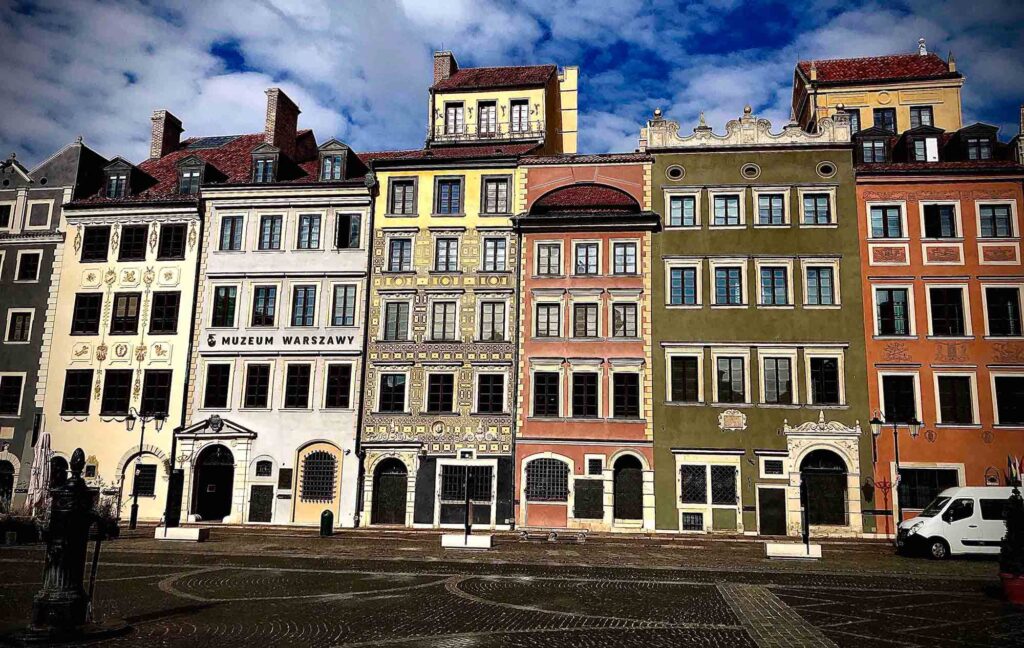 Colourful image of a street in Warsaw Poland, bold older buildings with no-one around