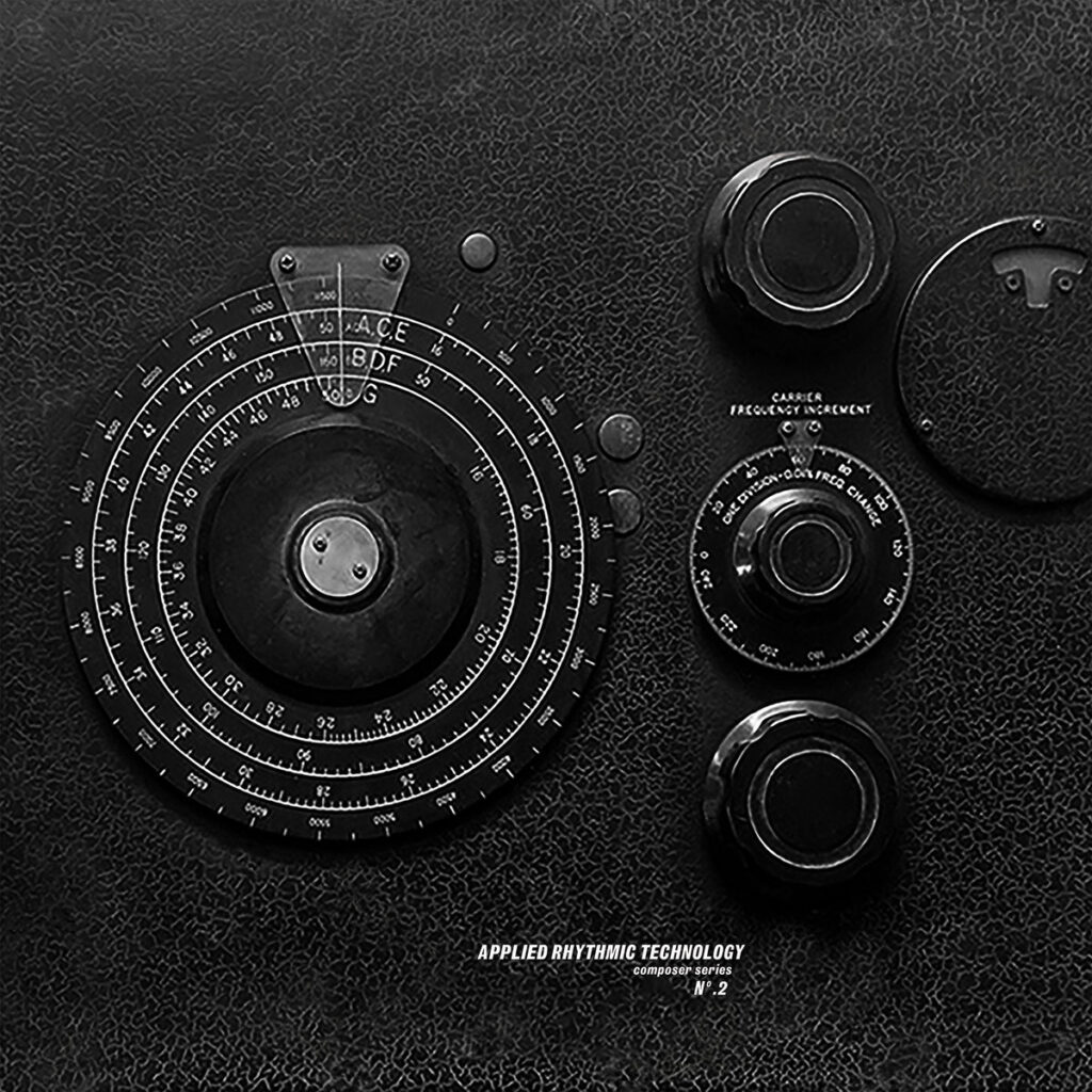 Bold black and white image of electronic dials on a black background. Some kind of musical modular synth, almost scientific 