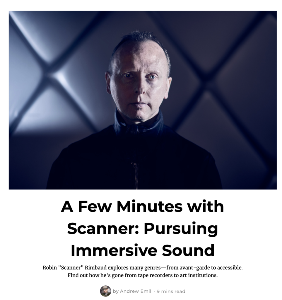 Portrait of a white handsome man, aged around 50, short blonde hair, leather jacket zipped to the next, standing in front of a padded wall, very dramatic pose. Underneath the photo a text reads 'a few minutes with Scanner: Pursuing Immersive Sound'
