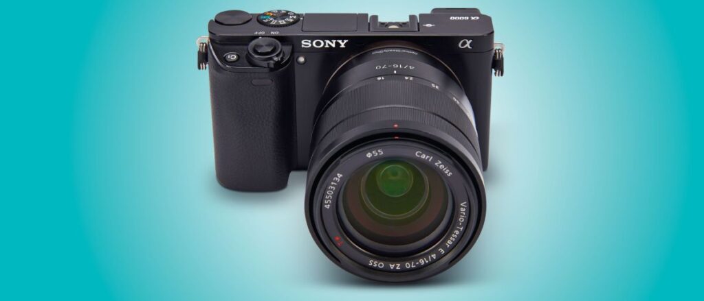 A Sony A6000 camera, with the camera in shot and blue light all around it.