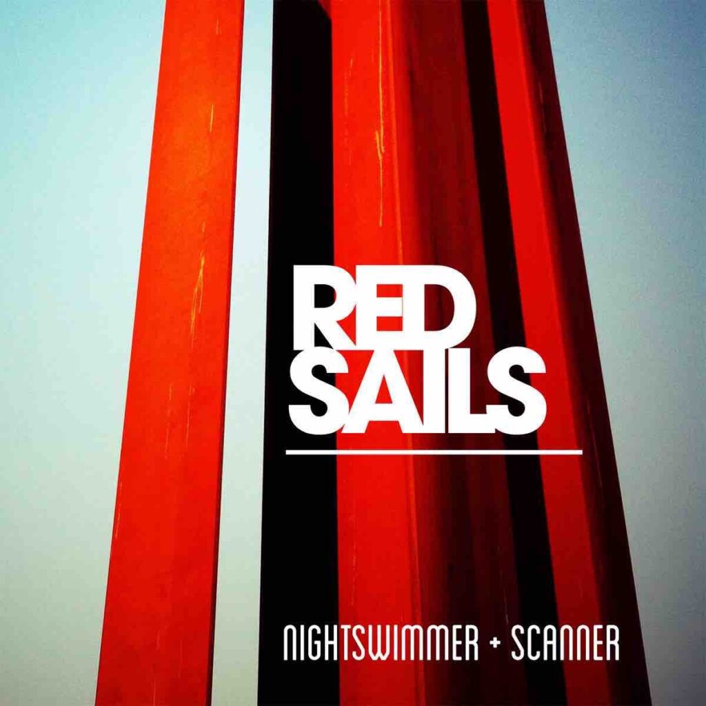 Bright read columns against a blank sky and the words RED SAILS printed across in red in the middle of the photo