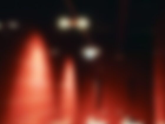 A blurry image with red light and dark colours, very abstract