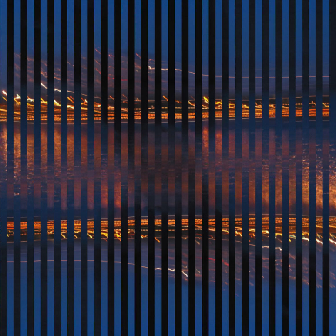 alt="Cityscape at night reflected on water, viewed through vertical black bars creating a striped pattern"