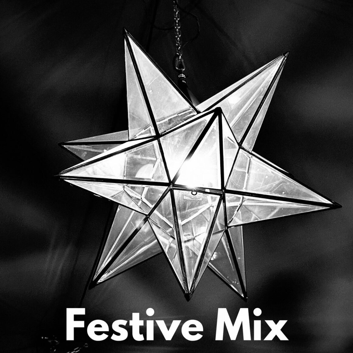 Geometric star-shaped pendant lamp that emits light with the text "Festive Mix" underneath.