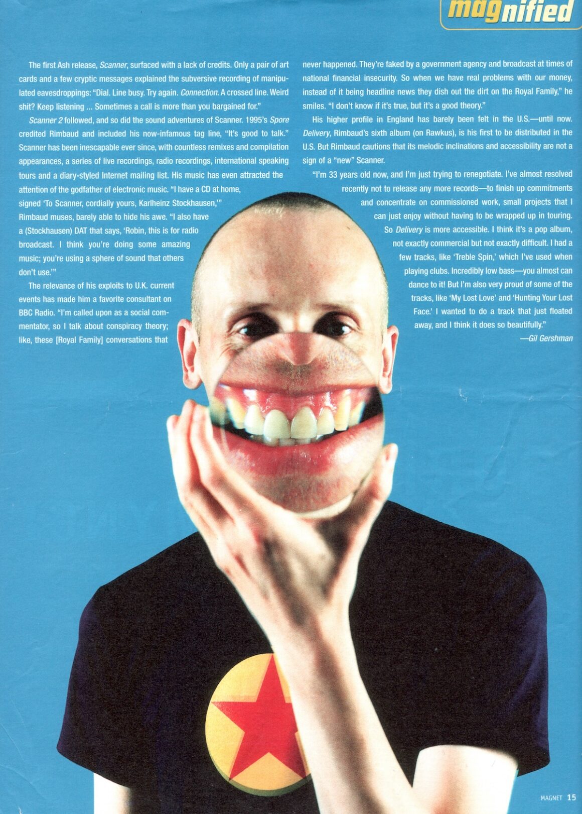 Magazine interview on blue background with a large image of a white man with cropped hair, as he holds a magnifying glass mouth, making it enormous