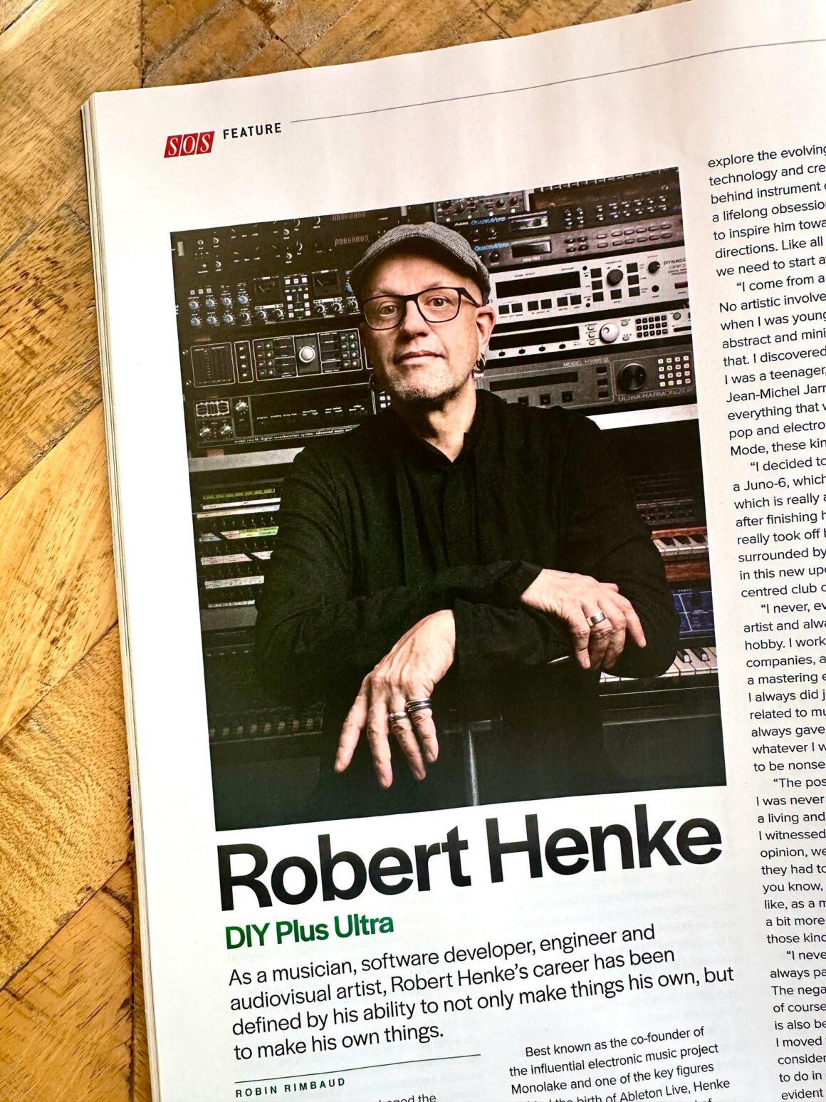 Portrait of Robert Henke in a magazine article titled "DIY Plus Ultra" with text describing his career as a musician, software developer, engineer, and audiovisual artist, set against a background of electronic music equipment.