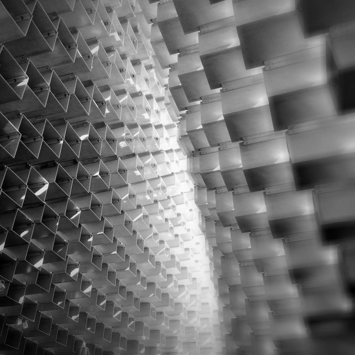 Abstract black and white photograph of hundreds of glistening cubes in the air