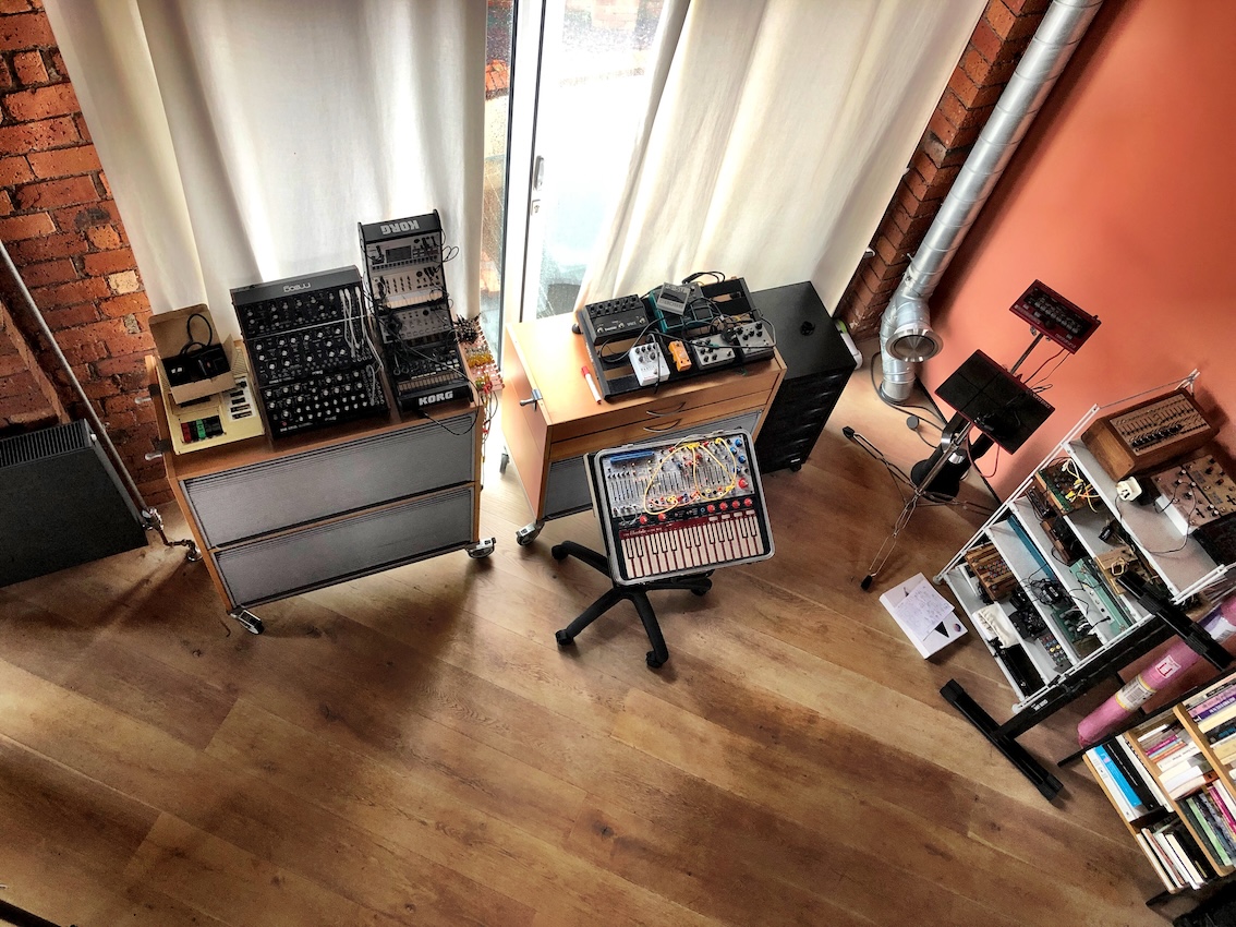 An overhead shot from above of music equipment in the studio, with a Buchla Easel and Moog synthesisers